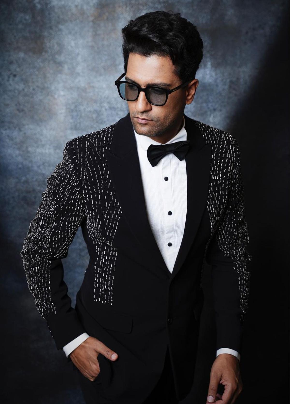 The 'Uri' star recently put his best fashion foot forward when he attended the Nykaa Femina Beauty Awards Show. Looking dapper as always, Vicky stunned when he arrived on the red carpet rocking a black tuxedo suit which consisted of an embellished single-lapel coat, matching straight-fitted pants with a crisp white shirt underneath. He kept it classy with a black bow tie. To round-off his red carpet look, Vicky rocked black-framed tinted sunglasses and sleek black shoes. With a back-swept hairdo and a clean-shaven face, the actor exuded elegance and glamour.   